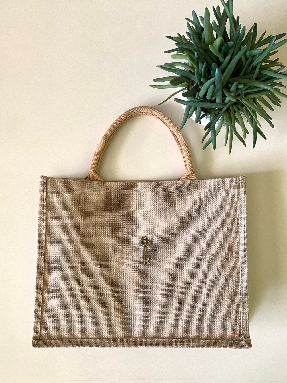 Elegant Tan Tote Bag with Key Charm Detail